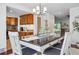 Bright dining room with stylish lighting, open to the kitchen and living spaces at 7589 S Cove Cir, Centennial, CO 80122