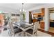 Dining room open to the kitchen, with hardwood floors and natural light at 7589 S Cove Cir, Centennial, CO 80122