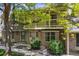Inviting townhouse exterior with brick facade, mature trees, and a private second-story balcony at 7589 S Cove Cir, Centennial, CO 80122