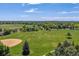 Large grassy field with distant views of trees and a baseball field, ideal for recreation and relaxation at 7589 S Cove Cir, Centennial, CO 80122