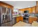 Updated kitchen featuring stainless steel appliances, granite countertops, and wood cabinets at 7589 S Cove Cir, Centennial, CO 80122