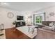 Bright living room with a large window, hardwood floors, and comfortable seating at 7589 S Cove Cir, Centennial, CO 80122