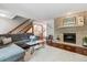 Cozy living room featuring a stone fireplace, hardwood floors, and comfortable seating at 7589 S Cove Cir, Centennial, CO 80122