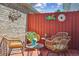 Inviting patio area with wicker furniture and charming decorative accents on the brick and wood walls at 7589 S Cove Cir, Centennial, CO 80122