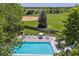 Aerial view of a pool with lounge chairs and mature landscaping, offering a tranquil outdoor space at 7589 S Cove Cir, Centennial, CO 80122