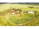 Aerial view of home, barns, and surrounding landscaping on a large lot at 1353 S Elbert St, Elizabeth, CO 80107
