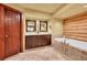 Modern bathroom with dual vanities, soaking tub, and log accent wall at 1353 S Elbert St, Elizabeth, CO 80107
