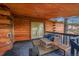 Cozy log cabin deck furnished with wood furniture and a view of the surrounding nature at 1353 S Elbert St, Elizabeth, CO 80107