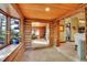 Inviting entryway with a log cabin design, tile floors, and large windows overlooking the landscape at 1353 S Elbert St, Elizabeth, CO 80107