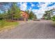 Rustic log home with gravel driveway and ample parking space at 1353 S Elbert St, Elizabeth, CO 80107
