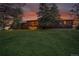 Log cabin home with a covered deck and a well-maintained lawn at 1353 S Elbert St, Elizabeth, CO 80107
