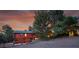 Log cabin home with a garage and driveway surrounded by trees at 1353 S Elbert St, Elizabeth, CO 80107