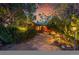 Charming log cabin with stone walkway, mature trees, and landscape lighting at 1353 S Elbert St, Elizabeth, CO 80107