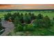 Idyllic home nestled in mature trees with a pool, patio, and lush landscaping creating a serene outdoor retreat at 1353 S Elbert St, Elizabeth, CO 80107
