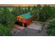 Exterior showing a charming home with a metal roof and an attached garage and rear gravel parking area at 1353 S Elbert St, Elizabeth, CO 80107