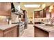 Modern kitchen features granite countertops, stainless steel appliances, and custom wood cabinetry at 1353 S Elbert St, Elizabeth, CO 80107