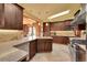 Modern kitchen features granite countertops, stainless steel appliances, and custom wood cabinetry at 1353 S Elbert St, Elizabeth, CO 80107