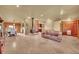 Expansive living room with stone fireplace, tile flooring, and log accents creating a cozy and inviting space at 1353 S Elbert St, Elizabeth, CO 80107