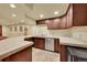 Basement wet bar area features stainless steel appliances and tile countertops at 1353 S Elbert St, Elizabeth, CO 80107