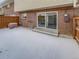 Exterior view of a backyard with brick and a sliding glass door at 3957 S Boston St, Denver, CO 80237