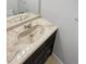 Bathroom sink with unique design elements, including a built-in sink and dark wood cabinet at 3957 S Boston St, Denver, CO 80237