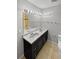 Well-lit bathroom featuring a double vanity, modern fixtures, and neutral tones at 3957 S Boston St, Denver, CO 80237