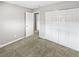 Bedroom features neutral colored walls, carpet, and a closet at 3957 S Boston St, Denver, CO 80237