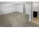 Bedroom with neutral carpet and an entrance to a tiled bathroom and access to hallway at 3957 S Boston St, Denver, CO 80237