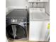 A laundry room with a black washing machine and white dryer at 3957 S Boston St, Denver, CO 80237