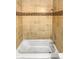 A close up of a shower featuring tile surround and white tub at 3957 S Boston St, Denver, CO 80237