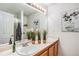 Bright bathroom featuring double sinks, a large mirror, and fresh white accents that add to its charm at 2488 W 111Th Pl, Denver, CO 80234