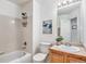 Bright bathroom features a shower-tub combo, a functional vanity with sink, and clean, neutral finishes at 2488 W 111Th Pl, Denver, CO 80234