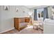 Bright Bedroom with natural wood crib, comfortable chair, and ample natural light, creating a serene space at 2488 W 111Th Pl, Denver, CO 80234