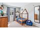 Stylish bedroom with a unique house-frame bed, playful decor, and ample natural light, ideal for a  at 2488 W 111Th Pl, Denver, CO 80234
