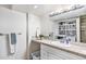 Functional laundry room with ample counter space, modern appliances, and stylish shelving for organized storage at 2488 W 111Th Pl, Denver, CO 80234