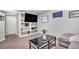 Cozy living room features built-in shelving, a sleek coffee table, and comfortable seating, perfect for relaxation at 2488 W 111Th Pl, Denver, CO 80234