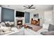 Cozy living room features a fireplace, TV, plush seating, and stylish decor for relaxation and entertainment at 2488 W 111Th Pl, Denver, CO 80234