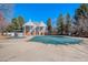 Outdoor pool with cover and neighboring buildings in community with lush trees at 2488 W 111Th Pl, Denver, CO 80234