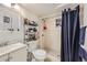 Functional bathroom featuring a shower, toilet, sink, and mirrored cabinet at 465 Miller Ave, Brighton, CO 80601