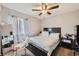 Cozy bedroom featuring a comfortable bed, a ceiling fan, and soft natural light at 465 Miller Ave, Brighton, CO 80601