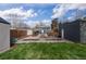 Landscaped backyard features a garden, shed, play area, and gray brick building at 1445 Ash St, Denver, CO 80220