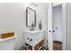 Charming bathroom with stylish fixtures, including a vanity with marble countertop and open shelving at 1445 Ash St, Denver, CO 80220