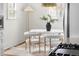 Dining area with a round table, plush chairs, and a modern floor lamp at 1445 Ash St, Denver, CO 80220