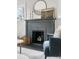 Close-up of the living room fireplace with decorative accents and nearby seating at 1445 Ash St, Denver, CO 80220