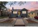 Charming home featuring a landscaped front yard, brick facade, and inviting entryway at 1445 Ash St, Denver, CO 80220