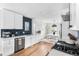 Bright kitchen with stainless steel appliances and a view into the dining room at 1445 Ash St, Denver, CO 80220
