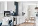 Modern kitchen with white cabinetry, stainless steel appliances, and a view to the dining area at 1445 Ash St, Denver, CO 80220