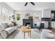 Bright living room and kitchen, with a fireplace and modern furnishings at 1445 Ash St, Denver, CO 80220