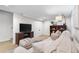 Cozy living room featuring a comfortable sofa, stylish ottomans, and a modern entertainment center at 1445 Ash St, Denver, CO 80220
