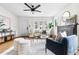 Bright living room features hardwood floors, a modern ceiling fan, and stylish, comfortable furniture at 1445 Ash St, Denver, CO 80220